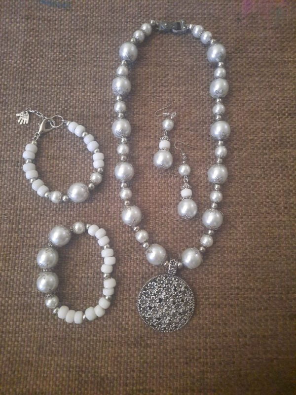 20240115_102504 White Flower Pendant Necklace Set - Elegant jewelry ensemble with metal pendant and white beads.