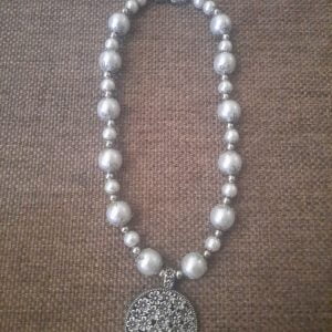 White Flower Pendant Necklace Set - Elegant jewelry ensemble with metal pendant and white beads.