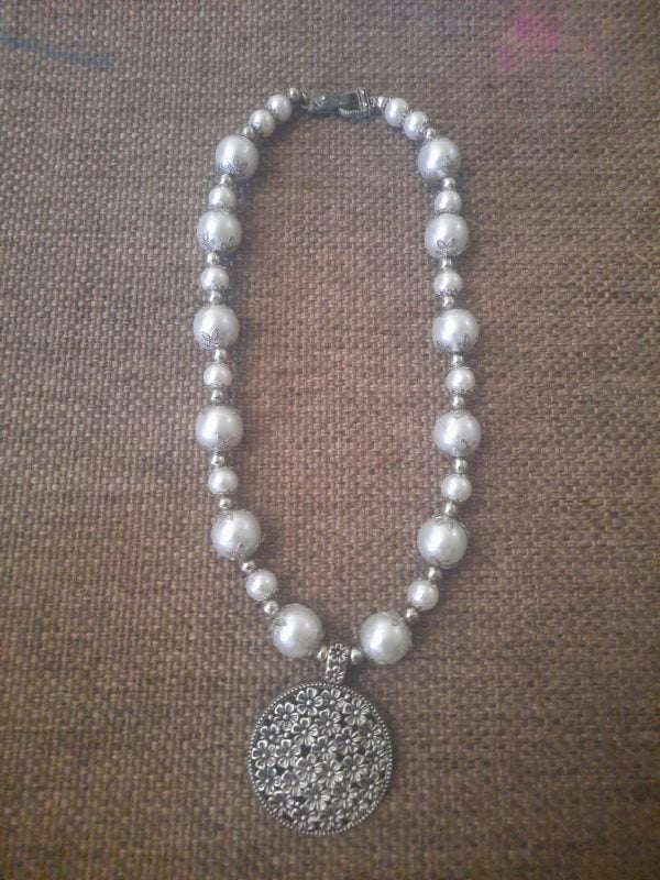 20240115_102721 White Flower Pendant Necklace Set - Elegant jewelry ensemble with metal pendant and white beads.