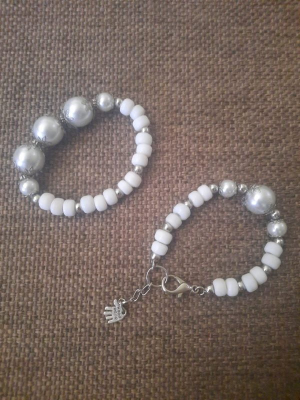 20240115_102756 White Flower Pendant Necklace Set - Elegant jewelry ensemble with metal pendant and white beads.