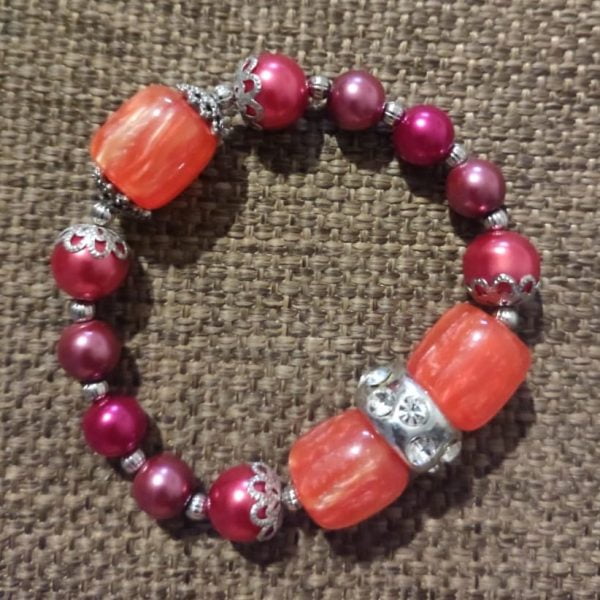 Flower Necklace Set 1 Flower Necklace Set - Handcrafted by RSart in South Africa, featuring maroon and cherry pink glass beads, silver accents, cylinder orange marble beads, flower pendant, and crystal slider bracelet detail.