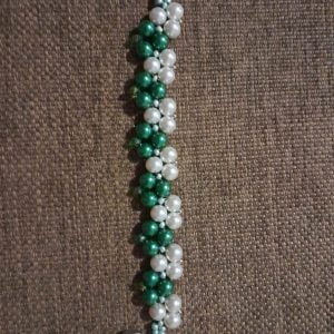 Green and White Pattern Bracelet - A cluster pattern of green and white pearl beads with silver charm and green crystal beads on the clasp.