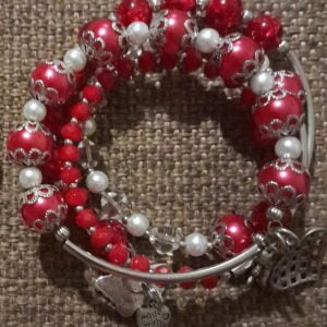 IMG-20240108-WA0040 Red Hot Bracelet Set - A stylish accessory set featuring red and white pearl beads, red crystal beads, silver caps, and charms.