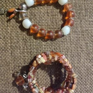 Brown Memory Wire Bracelet Set - Handcrafted by RSart in South Africa, featuring brown and white beads, silver caps, charms, rock beads, crystal beads, and painted heart-shaped beads.