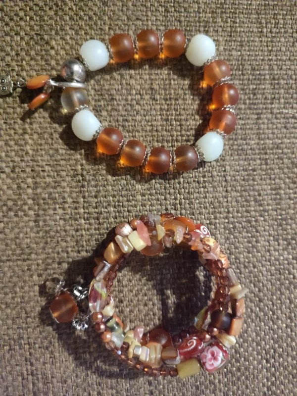 IMG-20240108-WA0048 Brown Memory Wire Bracelet Set - Handcrafted by RSart in South Africa, featuring brown and white beads, silver caps, charms, rock beads, crystal beads, and painted heart-shaped beads.