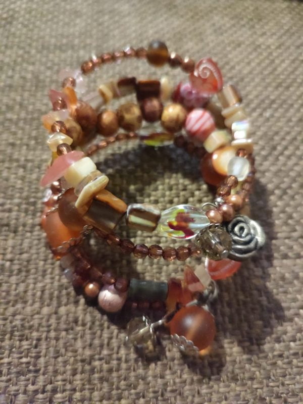 IMG-20240108-WA0049 Brown Memory Wire Bracelet Set - Handcrafted by RSart in South Africa, featuring brown and white beads, silver caps, charms, rock beads, crystal beads, and painted heart-shaped beads.