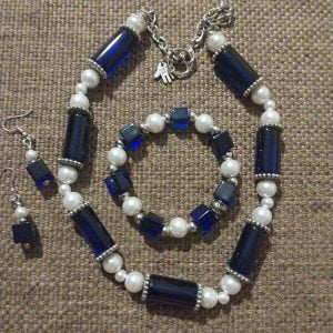 Silinder and Blocks Royal Blue Necklace Set Cylinder and Blocks Royal Blue Necklace Set - Featuring royal blue cylinder beads, white pearl beads, silver spacers, and matching bracelet and earrings.