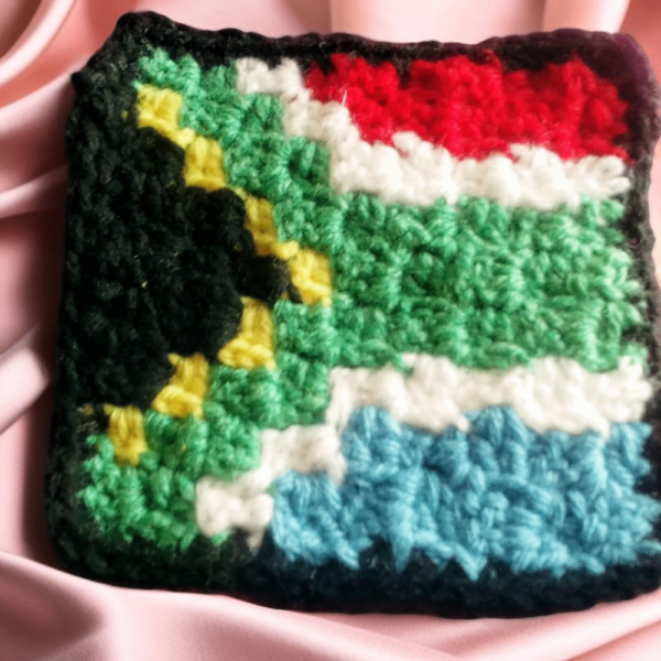 Hand-Crocheted South African Flag Coasters Showcase your love for South Africa with our hand-crocheted South African Flag Coasters. Made from 100% acrylic DK yarn, these coasters are both durable and decorative.