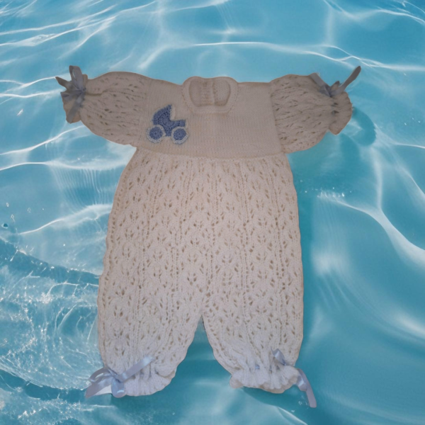 Handmade newborn knit romper for 0-3 months, featuring a soft lace pattern, blue embellishment, and ribbon details. Perfect for cozy comfort and special occasions.